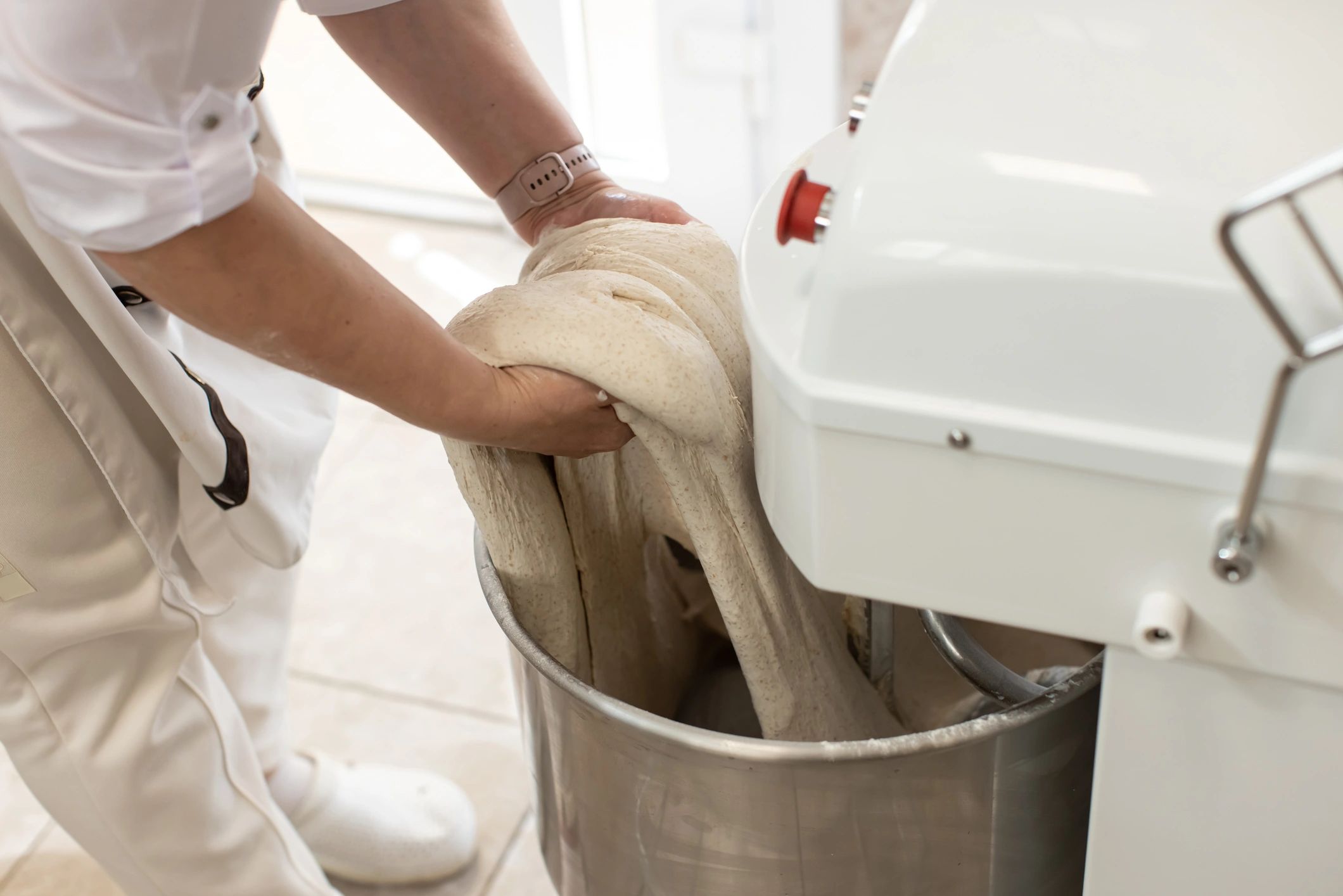 Baker kneading dough by hand